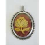A HM silver pendant having lacework rose within, hallmarked for Birmingham 1981, 5.3cm in length.
