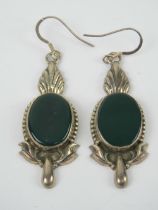 A pair of large silver earrings having central green oval panel and acanthus style decoration,