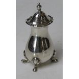 A HM silver pepperette raised over four pad feet, hallmarked for London 1922, standing 9cm high, 47.