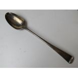 A HM silver serving spoon (hallmark almost erased) having shield engraving to terminal,