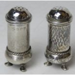 A pair of HM silver pepperettes having planished finish and hallmarked for Birmingham 1919,