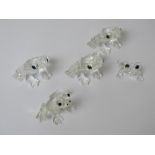 Four Swarovski crystal frog figurines, together with another similar, largest approx 3.5cm wide.