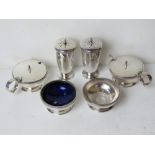 A silver plated cruet set comprising pair of pepperettes, pair of salts (one liner deficient),