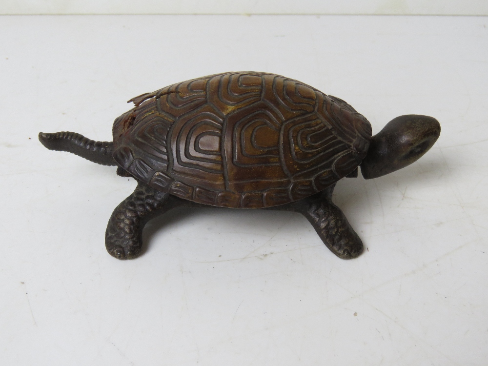 A clockwork tortoise, shell a/f, having hemispherical bell approx 15cm in length.
