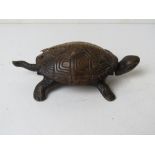 A clockwork tortoise, shell a/f, having hemispherical bell approx 15cm in length.