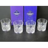 A set of four Edinburgh Crystal whiskey glasses with original packaging.