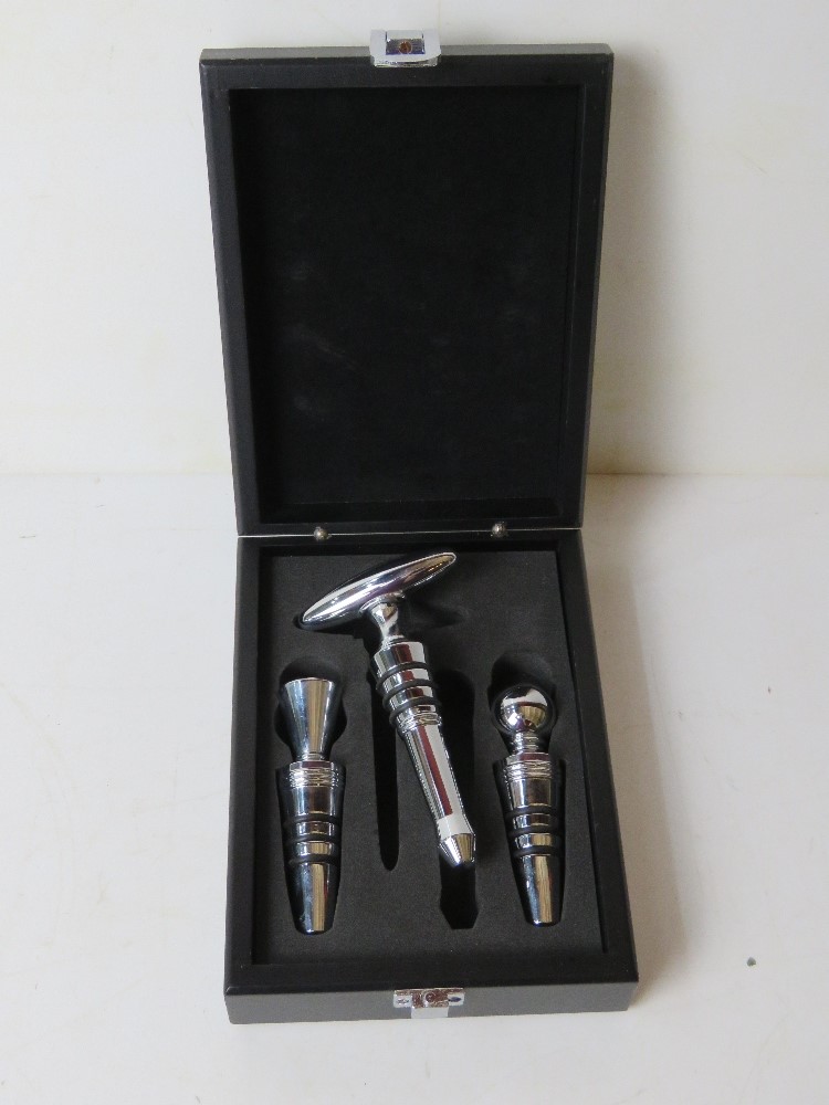 A set of three wine stoppers with corkscrew in presentation box.