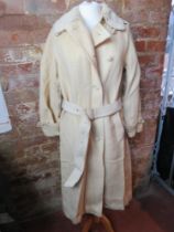 A ladies cream coloured 100% wool belted