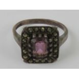 A silver marcasite and purple stone ring of Art Deco style, stamped silver, size K.