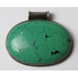 A large green hardstone pendant in white metal mount, stamped 925, approx 6cm wide.