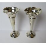 A pair of HM silver bud vases having fluted rims and weighted bases,