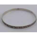 A silver bangle having Maltese cross pattern throughout and Maltese hallmark upon, 6.