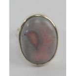 An unusual pink and lilac stone cabachon ring, stamped 925, size N.