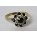 A 9ct gold sapphire and white stone floral cluster ring, hallmarked 375, size N, 2.3g.