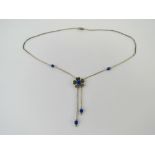 A Native American style silver beaded necklace having blue stone set floral design, marked Sterling.