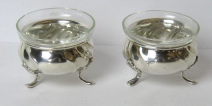 A pair of Carl M. Cohr (Fredericia, Denmark) silver plated salts having clear glass liners.
