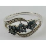 A contemporary silver cz set floral ring, stamped 925, size P-Q.