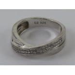 A contemporary silver ring set with cz stones, stamped 925, size N.