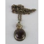 An unusual handmade purple and bronze hard stone pendant on silver chain, stamped 925.