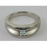 A HM silver ring having brushed and polished sections and central rectangular pale blue stone,