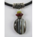 An agate pendant with white metal mount on black rubberised necklace having 925 silver clasp.