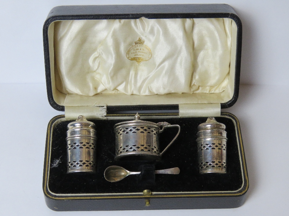 A boxed Art Deco HM silver cruet set comprising, salt and pepper pots with mustard pot and spoon,