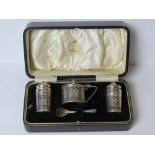 A boxed Art Deco HM silver cruet set comprising, salt and pepper pots with mustard pot and spoon,