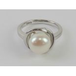 A silver and pearl ring stamped 925, size L.