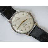 A vintage Longines manual wristwatch having subsidiary seconds dial and replacement strap.