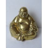 A brass Buddha sculpture standing 15cm high.