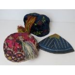 Three silken and velvet caps of Oriental style, two having tassels upon.