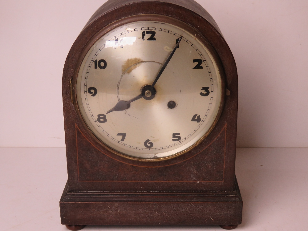 A vintage mantle clock having silvered dial with black painted Arabic numerals upon, with pendulum,