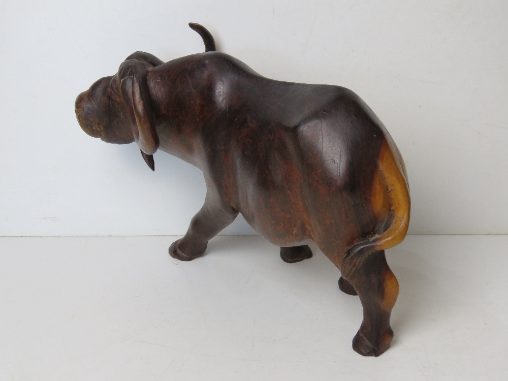 A large hand carved wooden figurine of a water buffalo approx 30cm in length. - Image 2 of 2