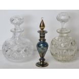 Two cut glass perfume bottles, each with stopper, together with Venetian style glass perfume bottle.