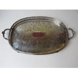 A silver plated serving tray having ball feet and twin end handles with clam shell decoration upon,