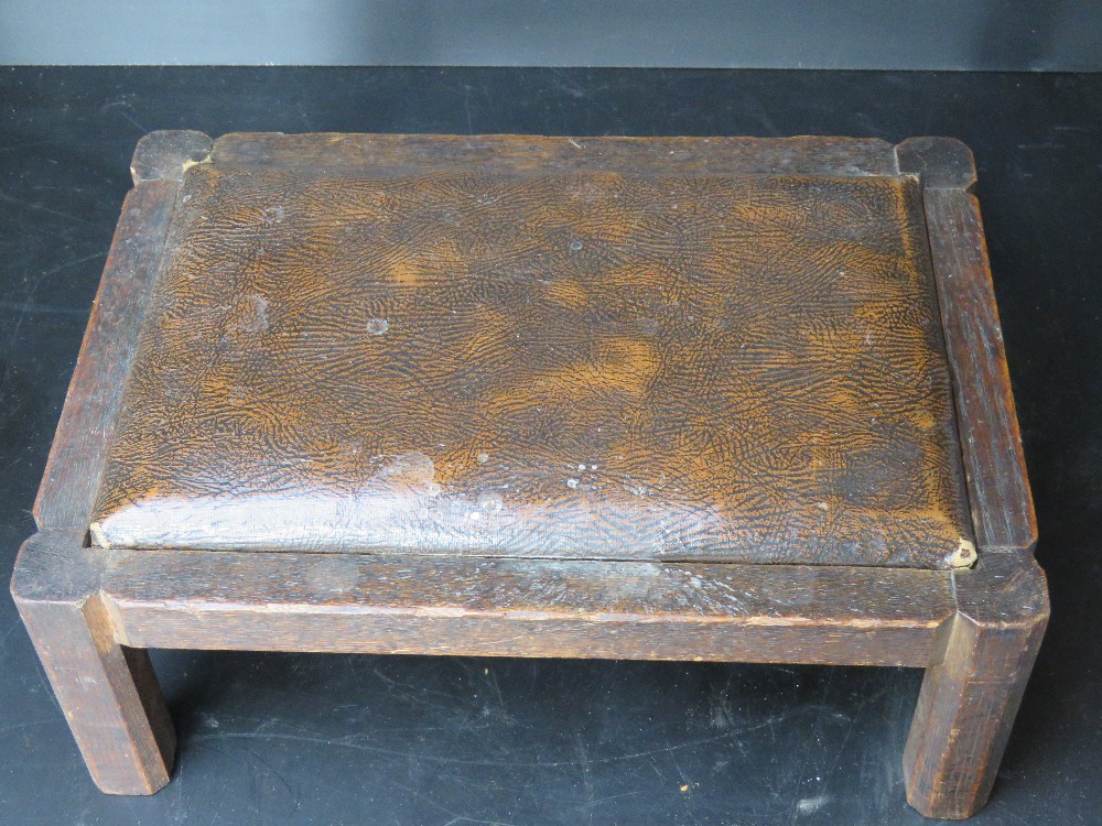 A small wooden and leatherette footstool, approx 34cm wide.