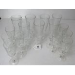 A set of seven champagne flutes together with a set of eight smaller matching dessert wine glasses.
