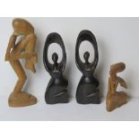 Four hand carved wooden figurines inc pair of fertility figurines standing approx 25.5cm high.