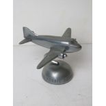 An aeroplane themed rotating desk ornament marked 'Fossil', approx 9.5 x 7cm.