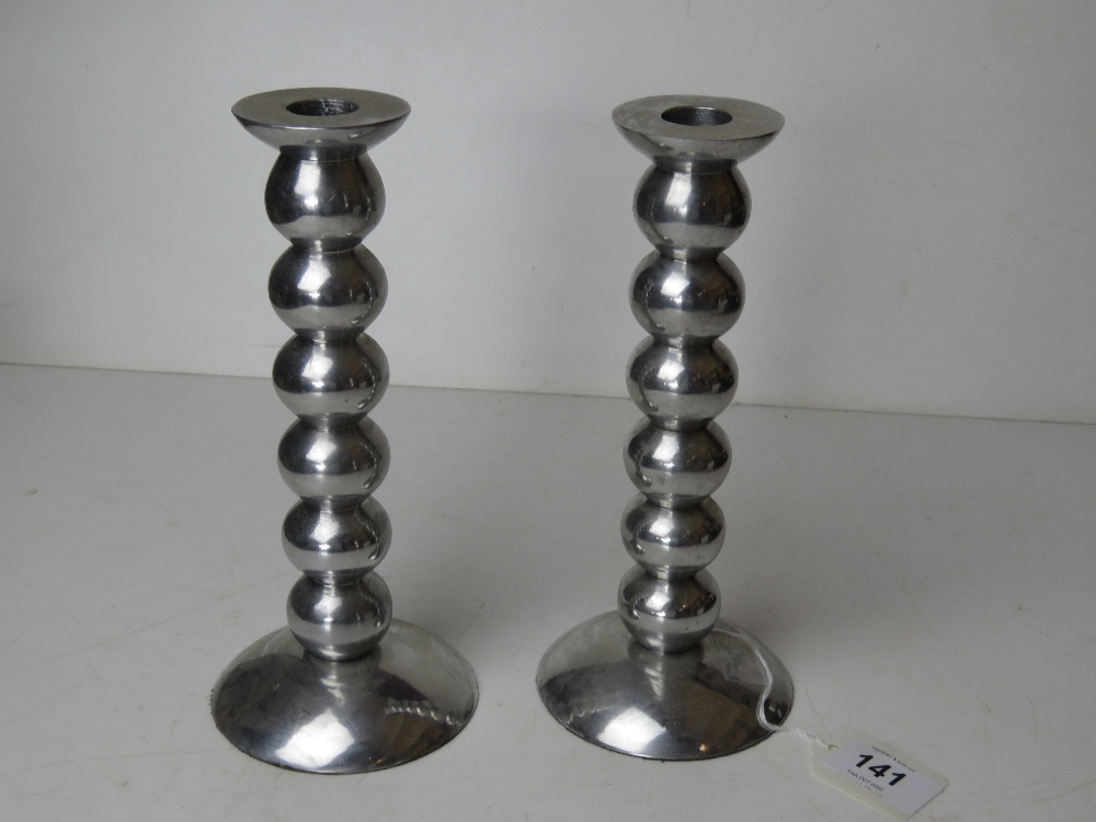 A pair of chrome bobbin turned style can