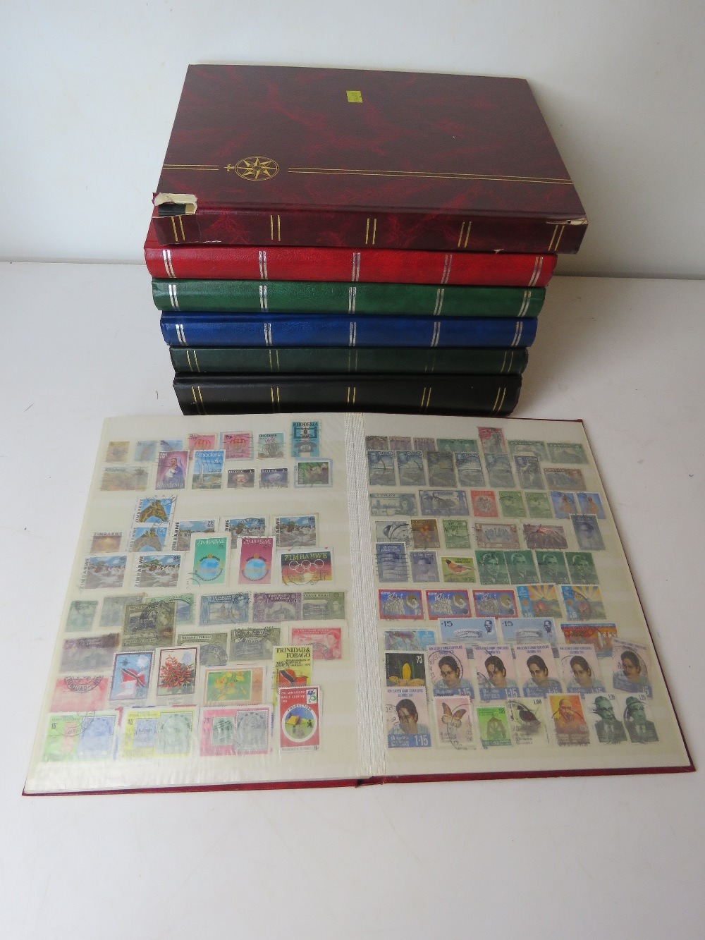 A collection of 20th century World Stamps in seven albums includes Ceylon and Rhodesia.