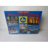 A Puzzle Exotica puzzle box having five 1000 piece puzzles, in original plastic.