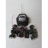 The chassis and wheels for a remote controlled vehicle, together with the controller.