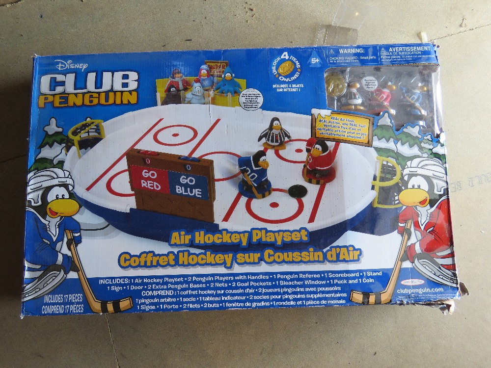 A Disney Club penguin air hockey playset