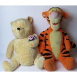 Two large Disney cuddly toys being Winnie the Pooh and Tigger.