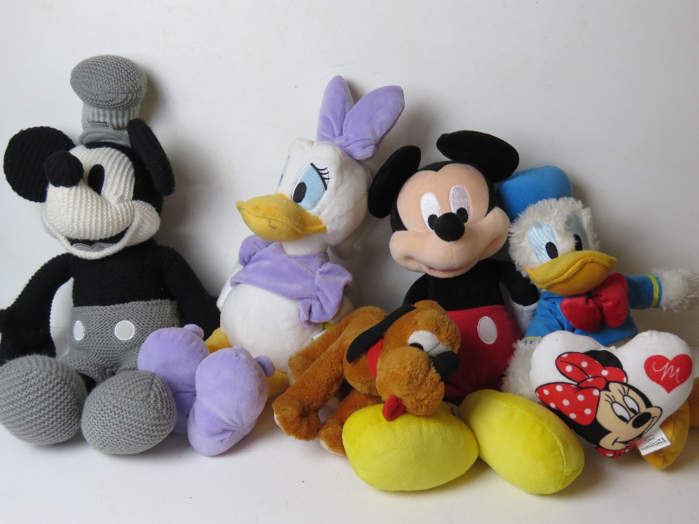 Five Disney cuddly toys and a cushion, inc Mickey Mouse, Donald Duck, Daisy Duck and Pluto.