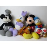 Five Disney cuddly toys and a cushion, inc Mickey Mouse, Donald Duck, Daisy Duck and Pluto.