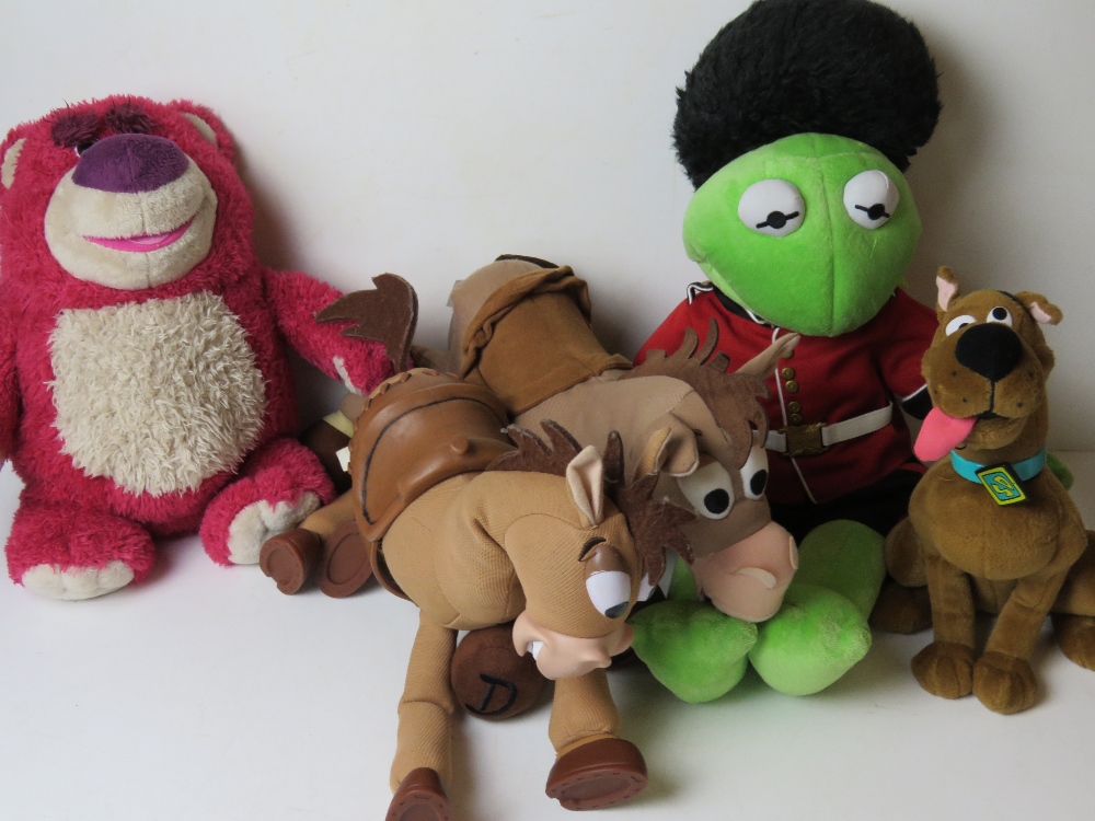 A Kermit the Frog cuddly toy, together with three Disney Toy Story and Scooby-Doo toy.