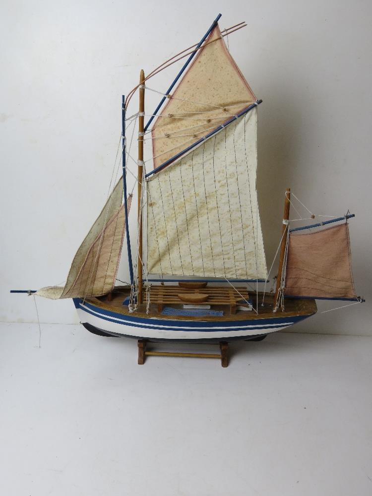 A model sailing boat having life boats and rigging measuring approx 70cm in length.