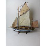 A model sailing boat having life boats and rigging measuring approx 70cm in length.